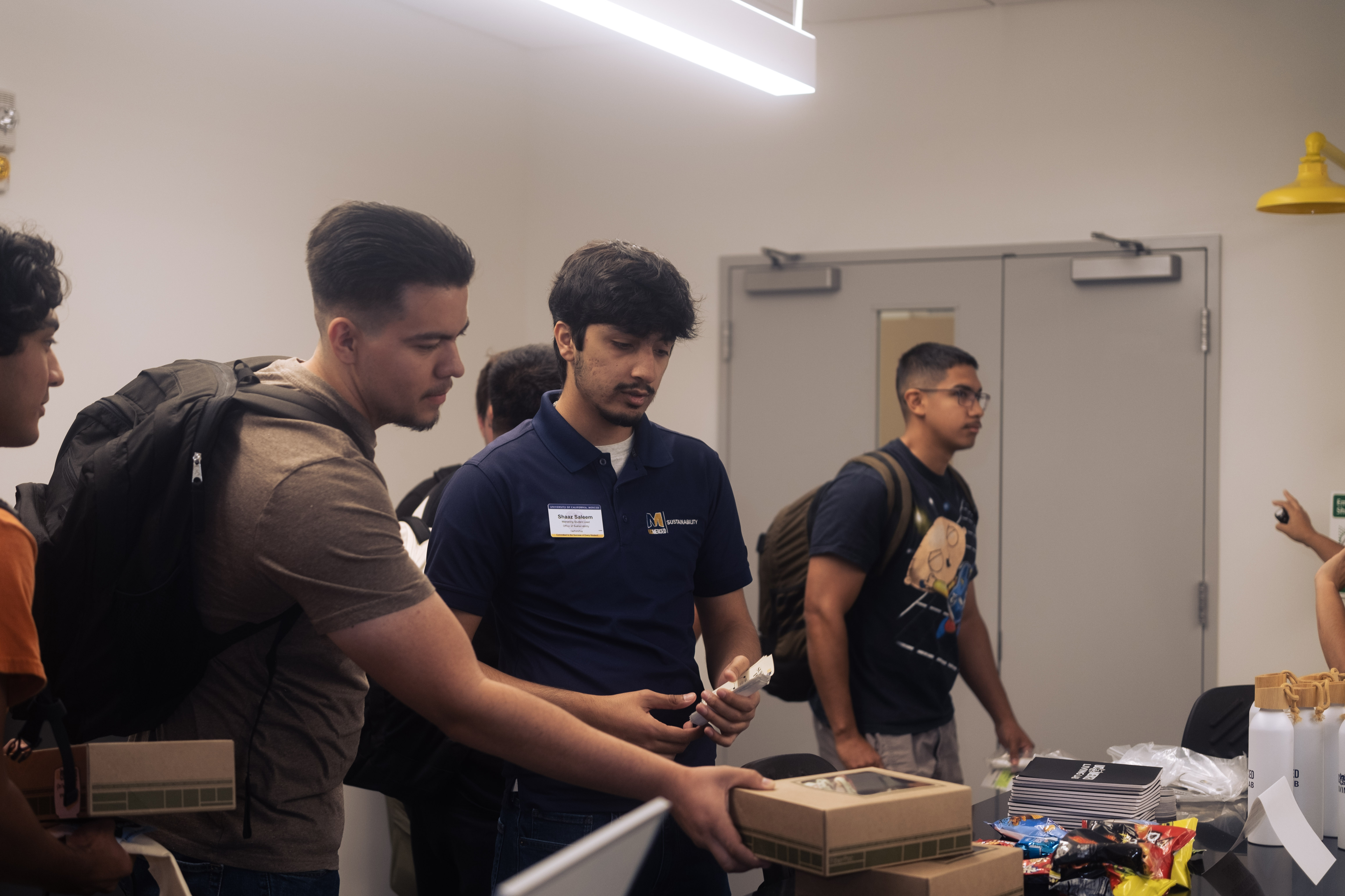 Shaaz helping people get their prizes for going to all of our tables