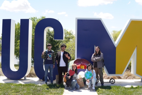 Students posing in front of UCM Sign